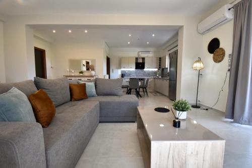 a living room with a couch and a table at PanMaria Sea View Garden Flat in Volos