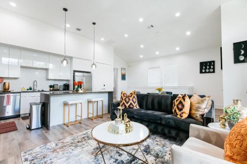 a living room with a couch and a table at Cozy and Chic 3BR Retreat in Downtown Houston in Houston