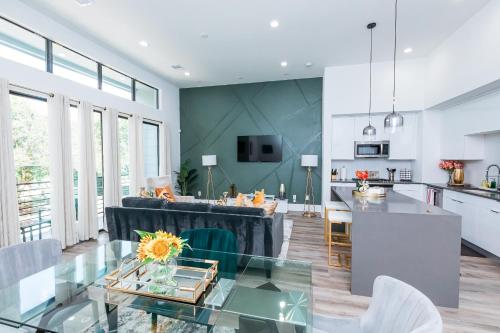 a kitchen and a living room with a glass table at Cozy and Chic 3BR Retreat in Downtown Houston in Houston