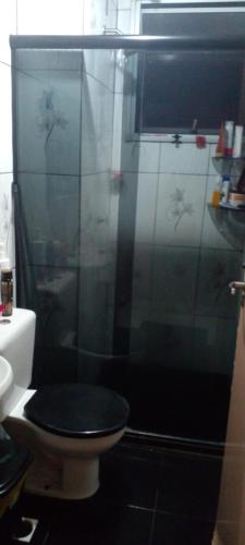 a bathroom with a toilet with a glass shower at cris Gomes cop30 in Ananindeua