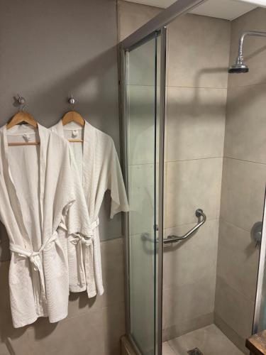 a bathroom with a shower stall with white towels at Pilar Suites by Viva in Pilar