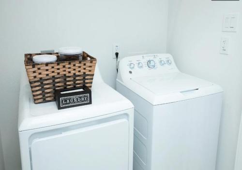 a white laundry room with a washer and dryer at Cozy and Chic 3BR Retreat in Downtown Houston in Houston