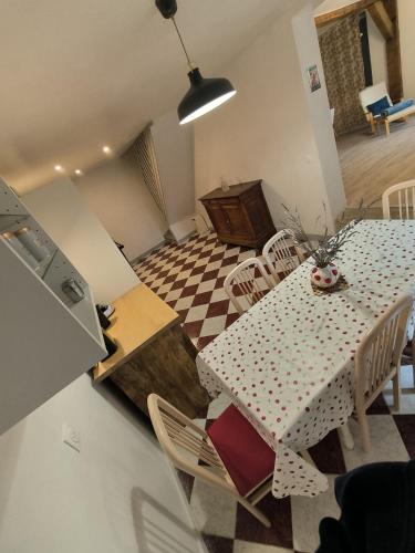 a kitchen and dining room with a table and chairs at La Maison bleue Paissy in Paissy