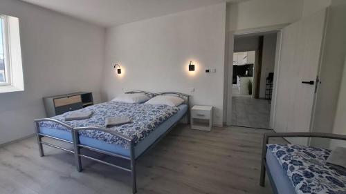 a bedroom with two beds and a hallway with a bathroom at Masarykova apartmens 8 in Teplice
