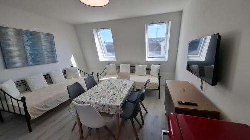 a room with a table and a bed and a tv at Masarykova apartmens 8 in Teplice
