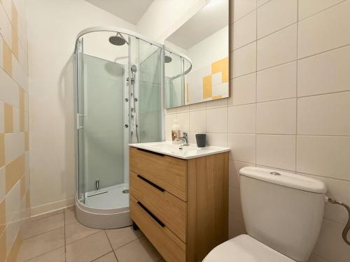 a bathroom with a shower and a toilet and a sink at Gîte de L'Olympe in Boulleret