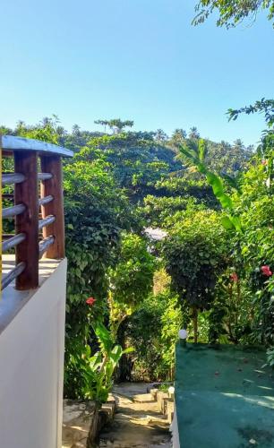 a view of a garden from the balcony of a house at Chalé na Praia da Tiririca in Itacaré