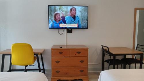 a tv hanging on a wall in a room at Ocean View Inn in Norfolk