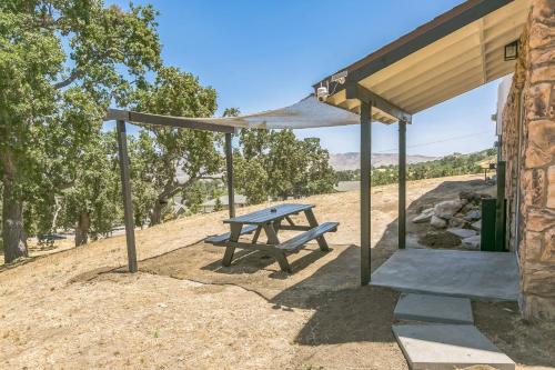 a picnic table under a canopy in a field at Desert Mountain Escape with Private Hot Tub home in Tehachapi