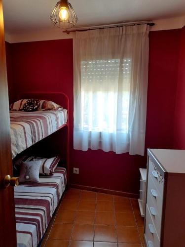 a bedroom with a bunk bed and a window at Canet playa in Canet de Mar