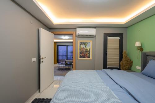 a bedroom with a blue bed and a room at Boutique Apartment with Sea View in Turunç Crush House in Turunc
