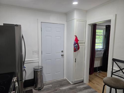 a room with a white door with a red coat on it at Charming 3 bedroom 2 bath home in Bloomfield with wishing well in Bloomfield