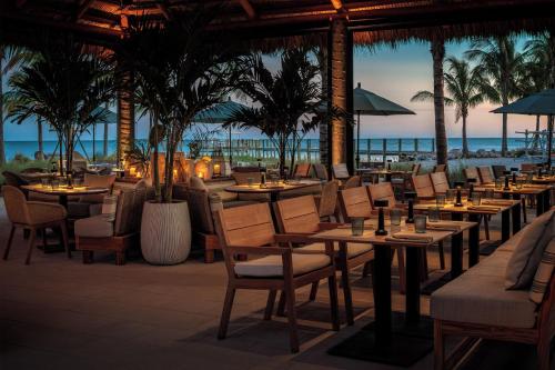 a restaurant on the beach with tables and chairs at Bayside Villas by Islander Resort in Islamorada