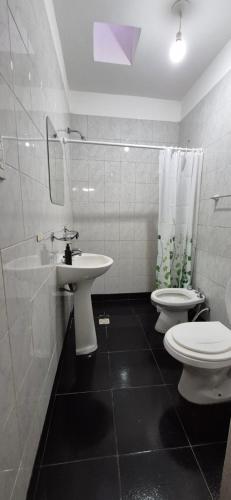 a bathroom with two toilets and a sink at Aire Serrano - Departamento San Luis in San Luis