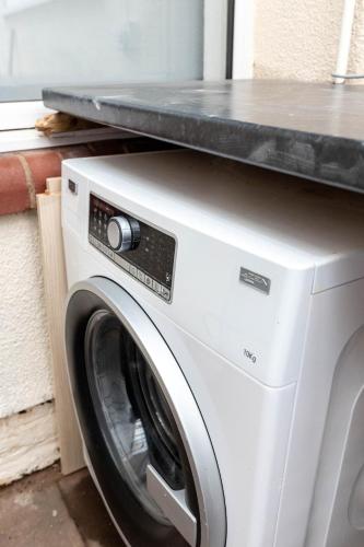 a washing machine with a counter on top of it at 4 Bedroom House in Wolverhampton Sleeps 8 Ideal for Contractors in Fallings Park