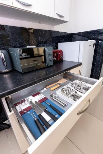 a kitchen drawer filled with lots of knives at 4 Bedroom House in Wolverhampton Sleeps 8 Ideal for Contractors in Fallings Park