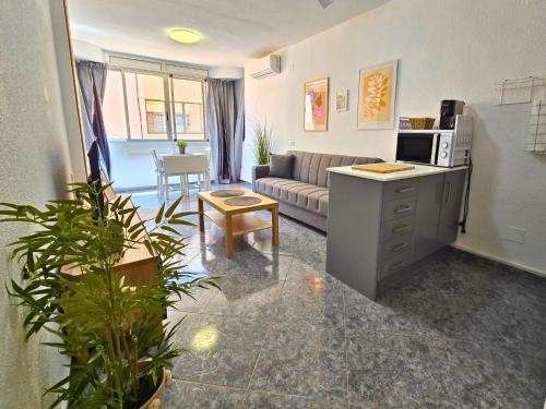 a living room with a couch and a table in a room at Sun & Playa 16 in Dehesa de Campoamor