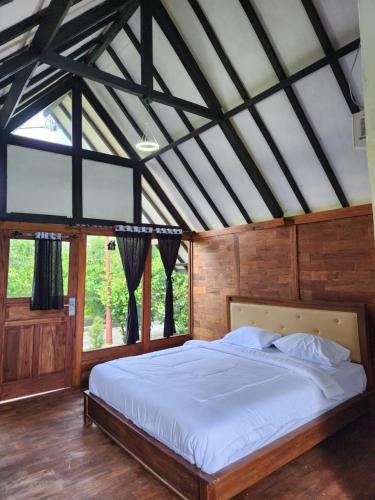 En eller flere senge i et værelse på Takamas Resort