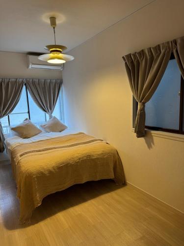 a bedroom with a bed and a ceiling fan at Harmonia - Nest in Osaka - in Osaka