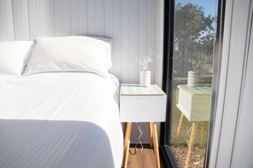 a bedroom with a bed and a view of a window at Sweet Retreat by Tiny Away in Bundaberg