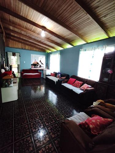 a large living room with couches and a table at Casa La Esperanza in Chachagua