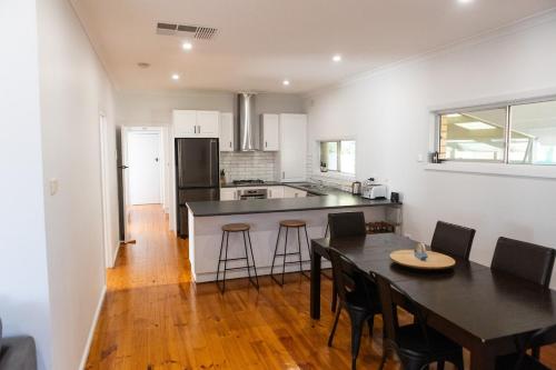 a kitchen and dining room with a table and chairs at North Central Spacious Charmer in Shepparton