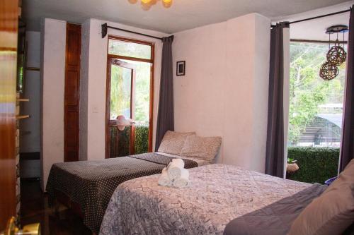 a bedroom with two beds with shoes on them at Hotel Diamantes Orizaba Boutique in Orizaba