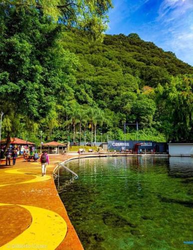 a person walking next to a body of water at Hotel Diamantes Orizaba Boutique in Orizaba
