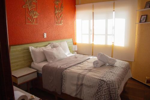 a bedroom with a bed with a stuffed animal on it at Hotel Diamantes Orizaba Boutique in Orizaba
