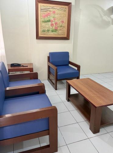 a waiting room with two chairs and a table at Joyce Apartelle San Juan in Manila