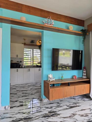a living room with a large blue wall at Rest in Paradise, Pool, Beach and Terrace in Sánchez