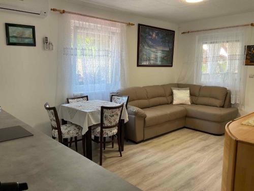 a living room with a couch and a table at Holiday Home Balatonbereny 16 in Balatonberény