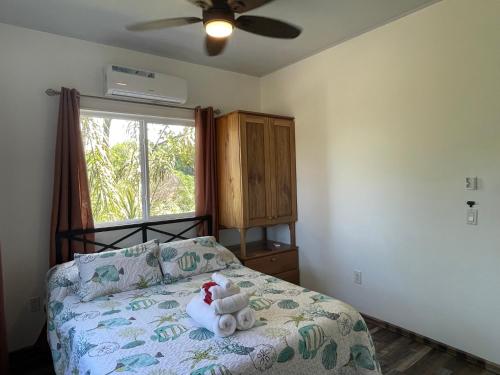 a bedroom with a bed with a teddy bear on it at Hidden Gem of Bocas in Bocas del Toro