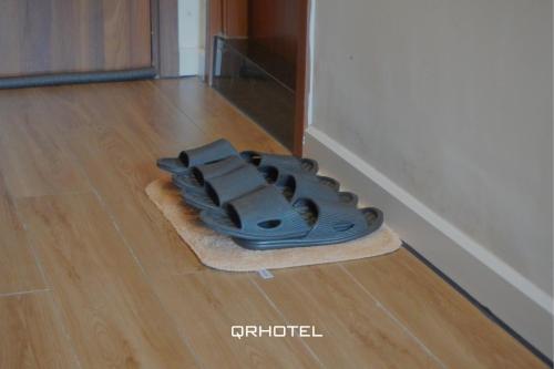 a blue object sitting on top of a wooden floor at QR Hotel Dalat in Xuan An