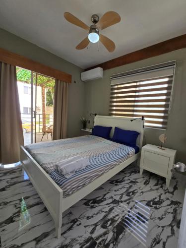 a bedroom with a bed and a ceiling fan at Rest in Paradise, Pool, Beach and Terrace in Sánchez