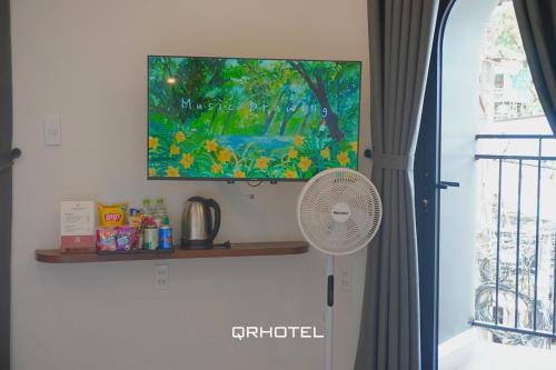 a fan sitting on a shelf next to a window at QR Hotel Dalat in Xuan An