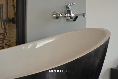 a white sink with a faucet in a bathroom at QR Hotel Dalat in Xuan An