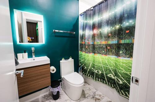 a bathroom with a baseball game mural on the shower curtain at Perch in Paradise EaglesThemed Escape in Philadelphia