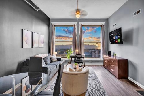 a living room with a couch and a table at Downtown Cleveland Loft Near CSU, Playhouse, Arena in Cleveland