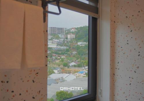 a window with a view of a city at QR Hotel Dalat in Xuan An