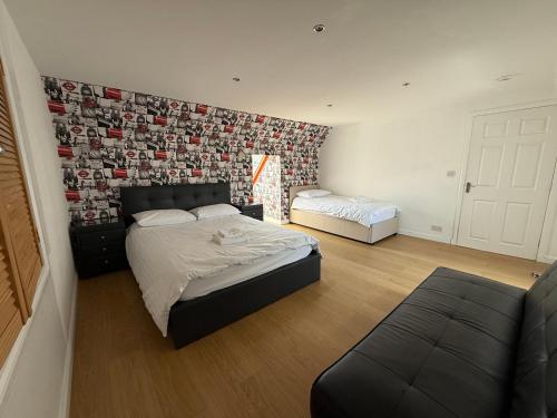a bedroom with a bed and a couch in it at Sunshine three bedrooms Apartment in Insch