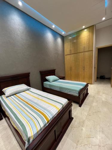 a bedroom with two beds in a room at Farm with villa and pool in Settat