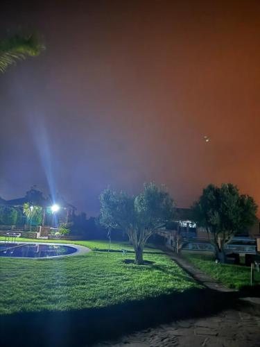 a view of a park at night at Farm with villa and pool in Settat