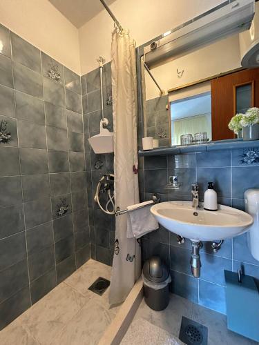 a bathroom with a sink and a shower at Korčula Guest House in Korčula