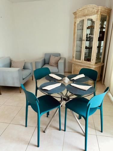 a living room with a table and chairs and a couch at Puerto Azul in Puerto Colombia