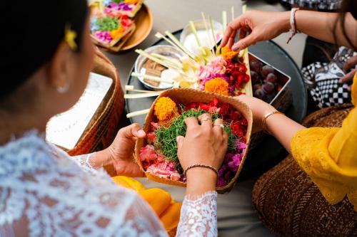 a group of people sitting around a table eating food at Alila Villas Uluwatu in Uluwatu