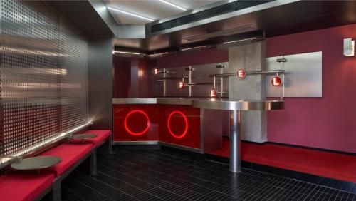 a restaurant with red seats and a table in a room at SFEEL设计师酒店Designer Hotel成都太古里春熙路步行街店 in Chengdu