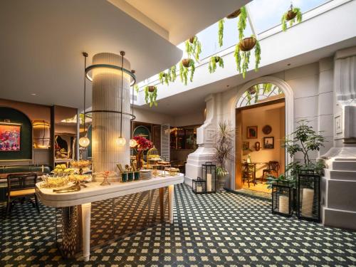 a lobby with a table and chairs in a building at Grand Madison Wuhan Hankou on the Bund in Wuhan