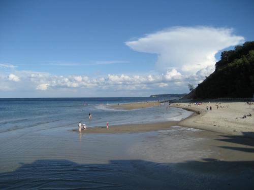 a group of people standing on a beach at Appartement auf Rügen in Sagard