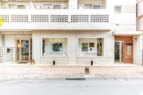 a store front of a building with glass windows at Casa Leo ASATO カサレオ安里 in Naha